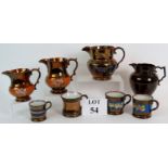 Four Victorian copper lustre ware jugs and four similar mugs, tallest is 15cm.