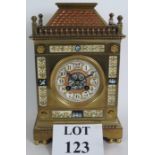 A 19th Century brass cased striking mantel clock in the Arts & Crafts style with highly decorated