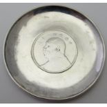 A small circular silver dish marked 'M Levy Sterling', and inset with a Chinese silver dollar.