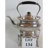 A rare antique Walker and Hall silver plated teapot with integral stand spirit burner.