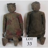 A pair of antique Chinese articulated carved wood dolls, male and female,