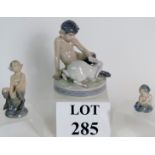 Three Royal Copenhagen porcelain figurines, one being a faun with rabbit, number 439,