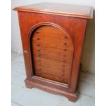 A fine 19th Century mahogany collector's cabinet with an arched door opening to reveal twelve glass