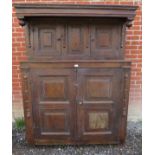 An 18th Century country oak court cupboard with two panelled cupboard doors to top over a further