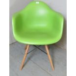 A cool retro moulded plastic chair finished in lime green and terminating on metal and wooden pin