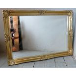 A 20th Century gilt framed rectangular wall mirror with bevelled glass.