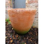 A decorative terracotta garden urn with a green base. Condition report: In good overall order.
