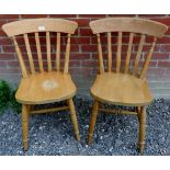 A pair of 20th Century beech kitchen chairs. Condition report: Scratches and scuffs visible.