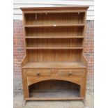 A 19th Century pine high back dresser with plate rack top over two small drawers and cupboard doors