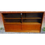 A mid - late 20th Century teak narrow freestanding bookcase manufactured by 'Herbert E Gibbs',