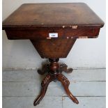 A 19th century walnut sewing table with a lift up top revealing a lined interior with fitted