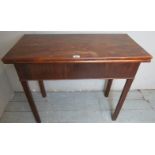 A Georgian mahogany turn over tea table of simple form terminating on chamfered legs.
