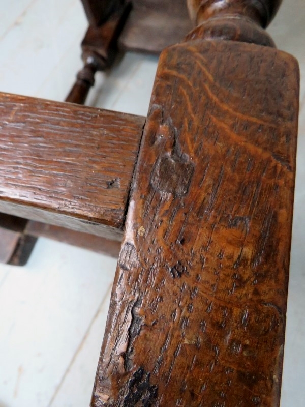 A 17th Century and later country oak joint stool with a carved linen fold frieze over turned - Image 8 of 8