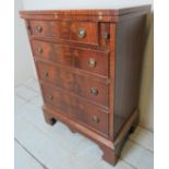 A 20th century Georgian-style mahogany bachelors chest of drawers with a turn over top over one
