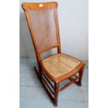 A fine Victorian walnut rocking chair with re-caned seat and back panel .