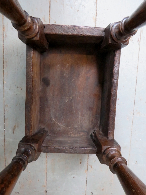 A 17th Century and later country oak joint stool with a carved linen fold frieze over turned - Image 5 of 8