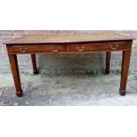 A Large Edwardian style desk with an inset tan leather top over two long drawers and tapered legs.