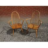 A pair of mid-century Ercol pale blonde Windsor quaker hoop back carver chairs Condition report: