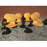 A set of six Fritz Hansen design stacking pressure treated chairs with chrome legs.