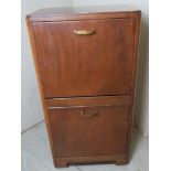 A 20th Century cabinet with two deep fall front drawers opening to reveal internal fitted vinyl