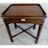 A small 20th century side table with a tray top over ornate base.