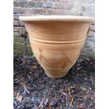 A decorative large Grecian style terracotta garden urn / pot.