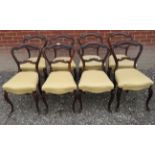 A fine set of eight carved rosewood framed Victorian dining chairs upholstered in a cream material