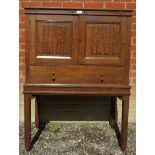 A period-style oak collectors cabinet with linen fold panelled doors opening to reveal an