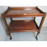 An early - mid 20th Century mahogany two tier buffet tea trolley terminating on metal castors.