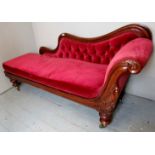 A Victorian mahogany framed chaise lounge upholstered in a red material with a seperate loose seat