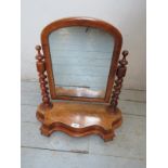 A pretty Victorian mahogany serpentine fronted vanity mirror with barley twist supports.