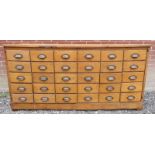 A cool vintage oak and pine bank of haberdashery drawers comprising of 30 drawers having metal