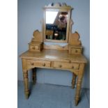 A Victorian pine dressing table with a central mirror to top over two small drawers and having two