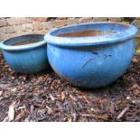 Two small garden pots finished in blue mottled paint effect.