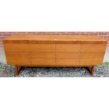 A Mid-century Danish teak sideboard with four cupboard doors to base opening to reveal internal