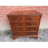 A small 20th Century Georgian design mahogany chest of four long graduated drawers terminating on