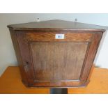 A small Edwardian oak wall hanging corner cabinet.