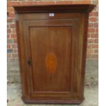 A 19th Century inlaid oak corner cabinet with an internal painted and shaped shelf.