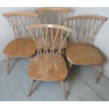 A set of four mid-century Ercol Windsor candlestick back chairs.