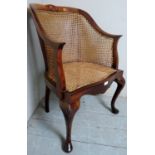 A 20th Century mahogany framed bergere tub chair with cane work to back,