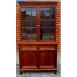 A C1900 mahogany Bookcase with a large two door display cabinet above two drawers over two cupboard