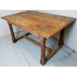 A Georgian design solid oak country refectory dining table with a planked top over a lower centre