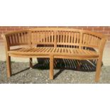 An excellent quality teak garden 'Peanut' style bench,