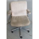 A contemporary swivel office chair upholstered in a cream material (matching previous