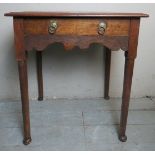 A 19th century oak lowboy with a single drawer above a carved frieze and terminating on pad feet.