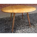 A mid-century Ercol pale blonde drop leaf occasional / dining table.