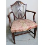 A Hepplewhite style mahogany elbow chair with a shield back having carved wheatsheaf design over an