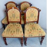 A set of four Victorian oak framed dining chairs with cream upholstery to back and seats over