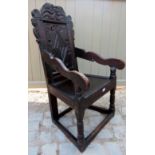 A fine 17th Century oak Wainscot chair having a carved diamond motif and scrolls and bearing 'S.