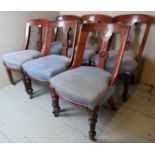 A harlequin set of six Victorian carved mahogany framed dining chairs upholstered in a blue